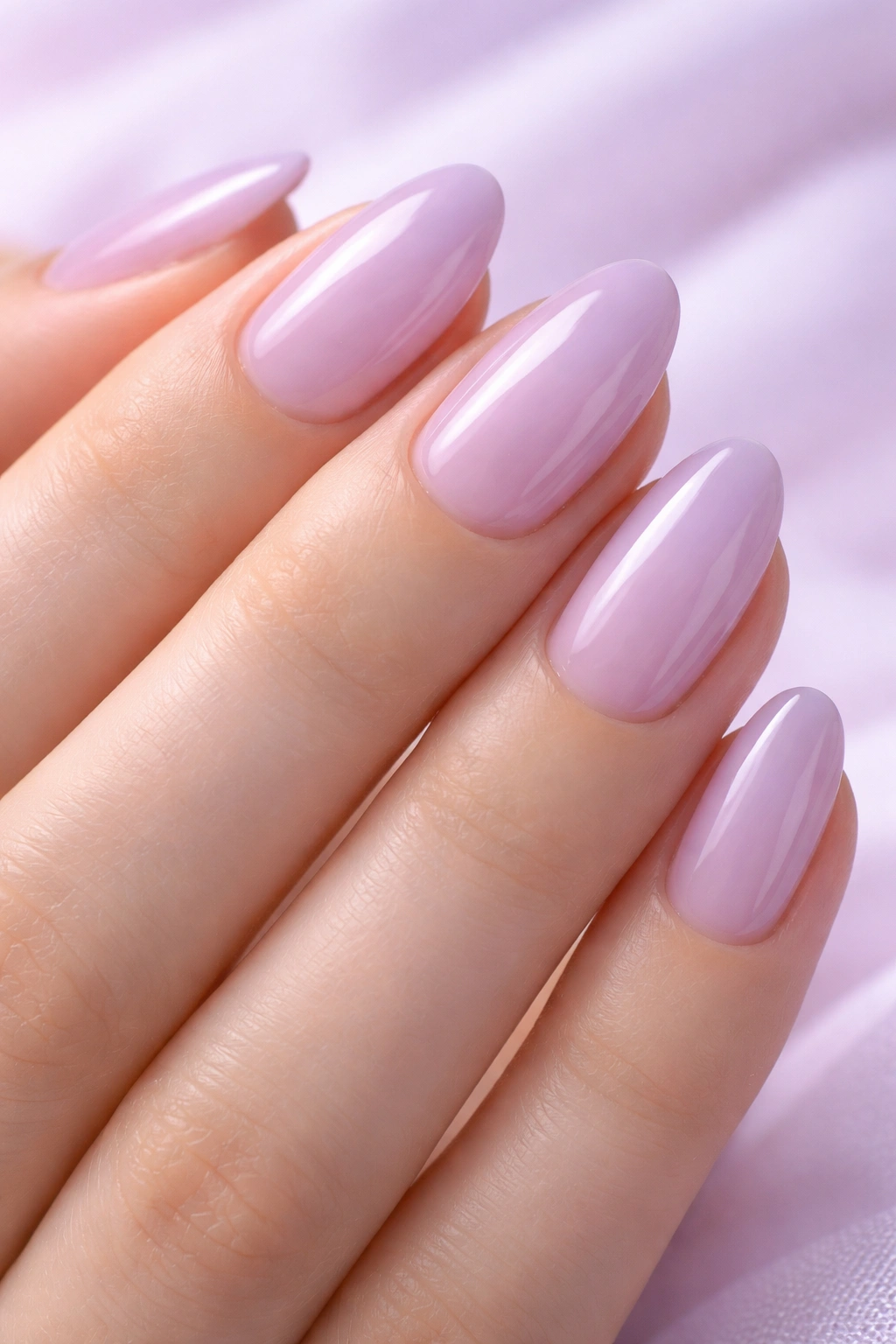 Close-up of sheer lavender almond nails showing translucency