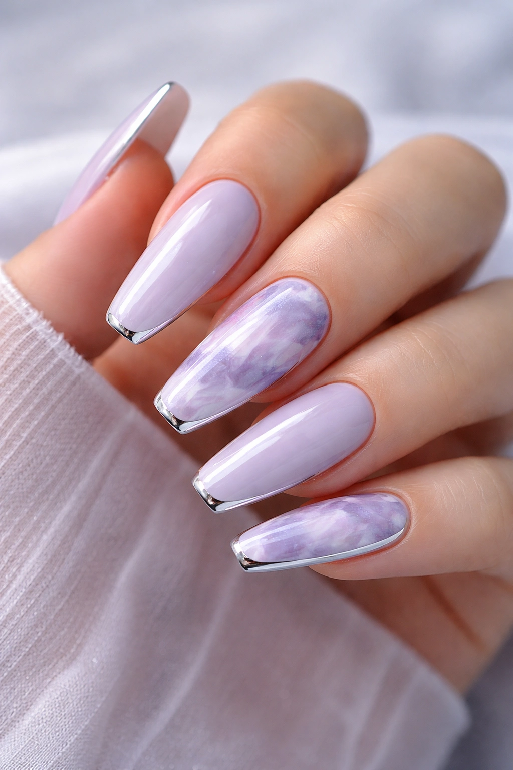 Lavender cloud marble nails with chrome edges on a ballerina manicure