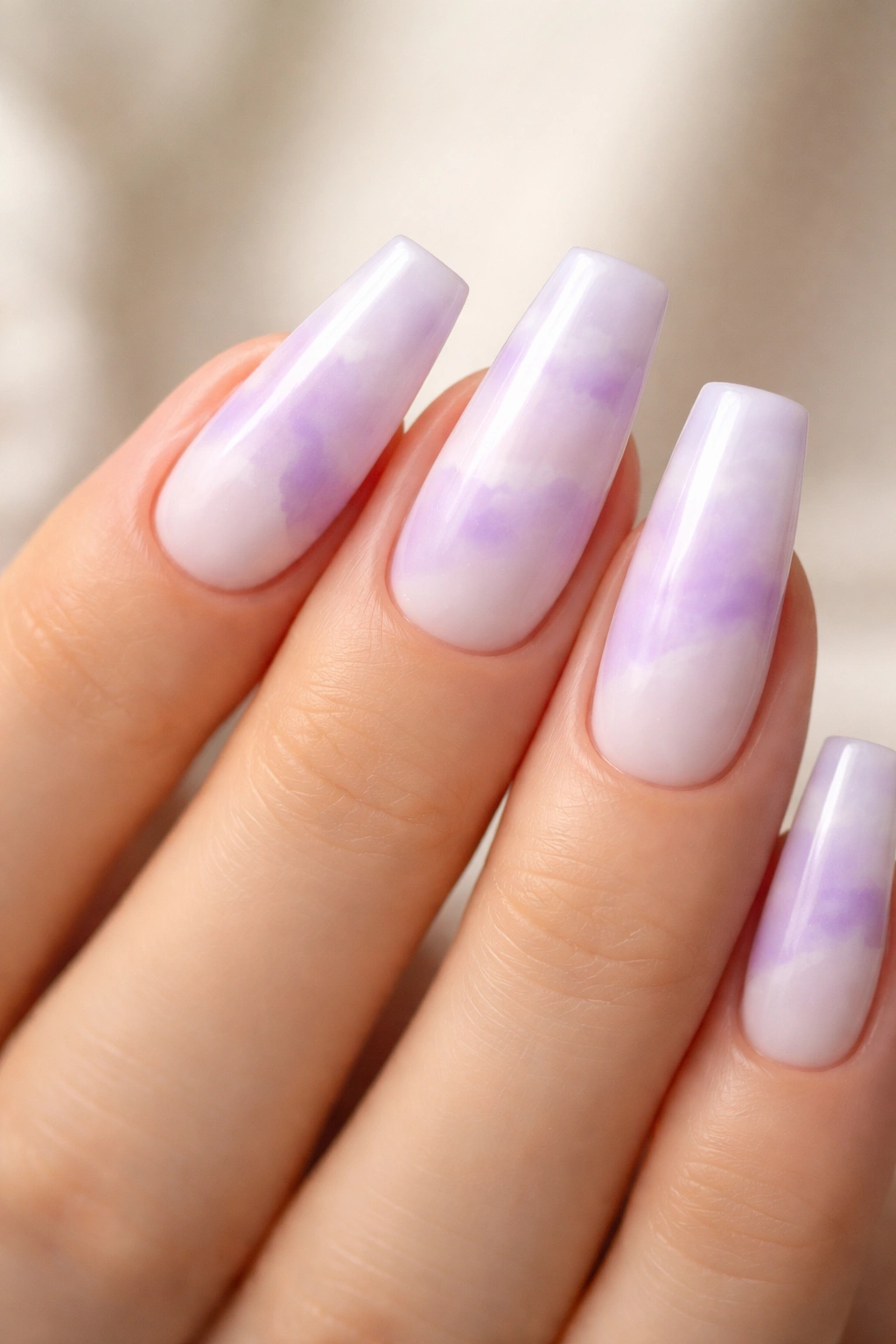 Close-up of lavender cloud ballerina nails with diffused purple patches.