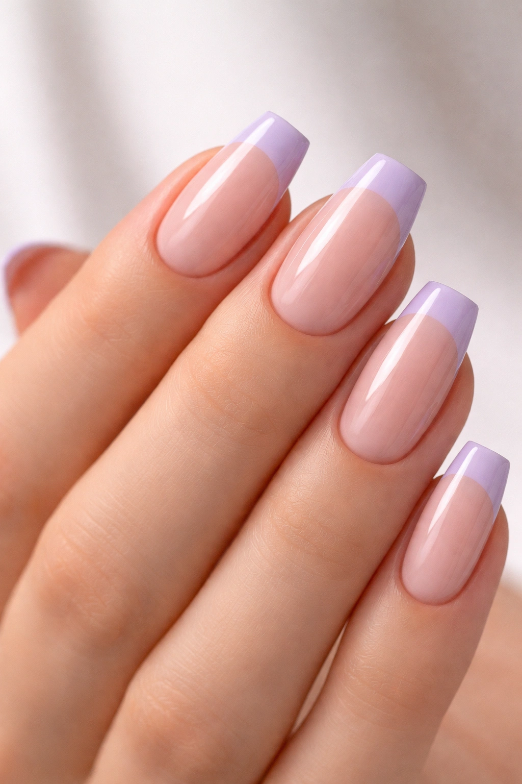 Close-up of lavender French tips on sheer nude base