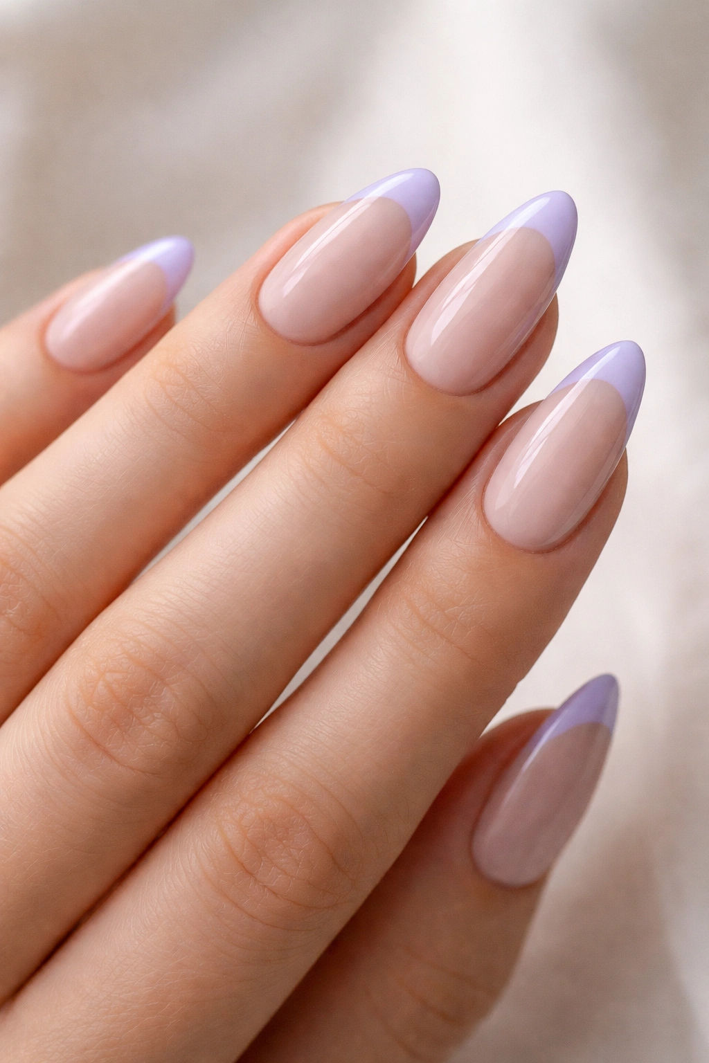 Almond nails with lavender French tips on a nude base