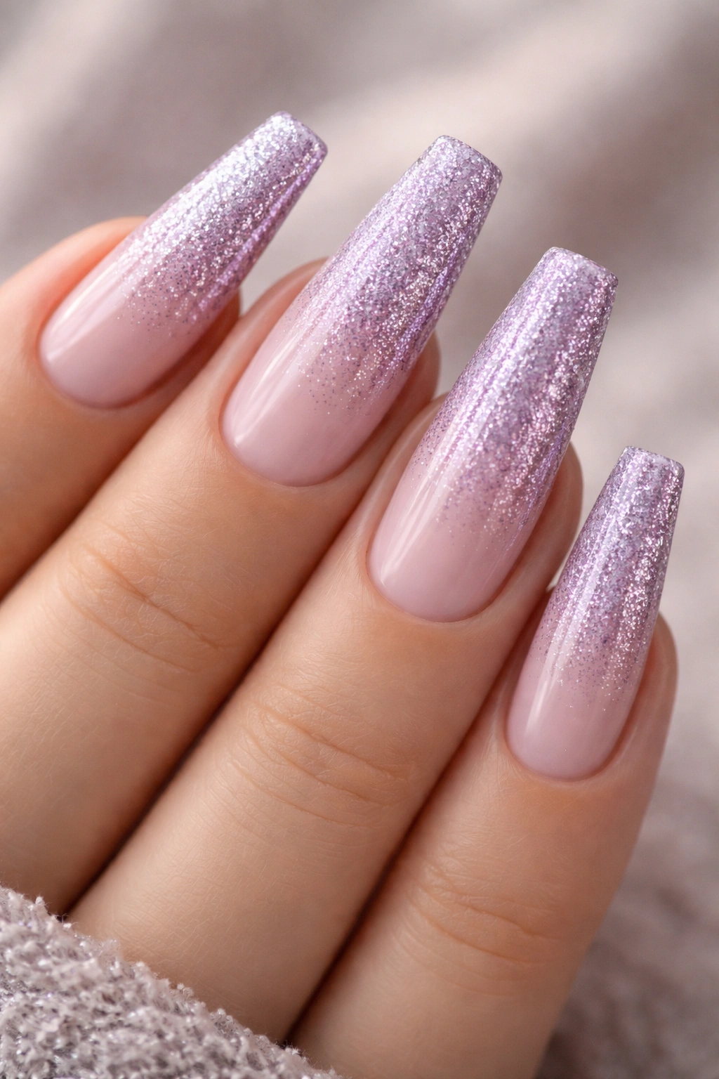 Coffin nails with sheer lavender base and glitter gradient to tips