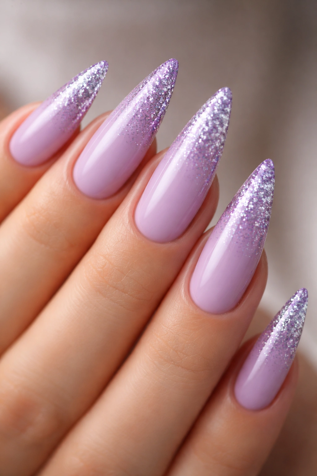 Close-up lavender nails with glitter ombré tips