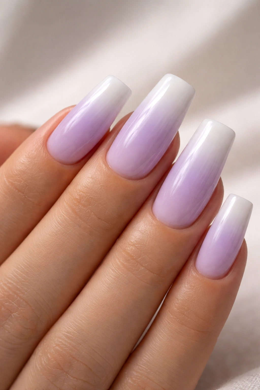 Soft lavender duck nails gradient to white with painterly brushstrokes