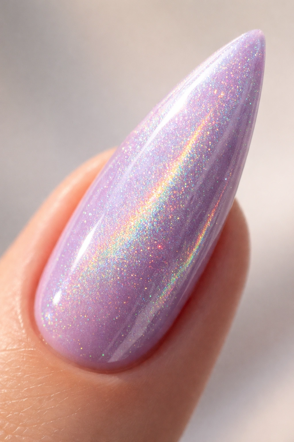 Soft lavender curved stiletto nail with holographic shimmer