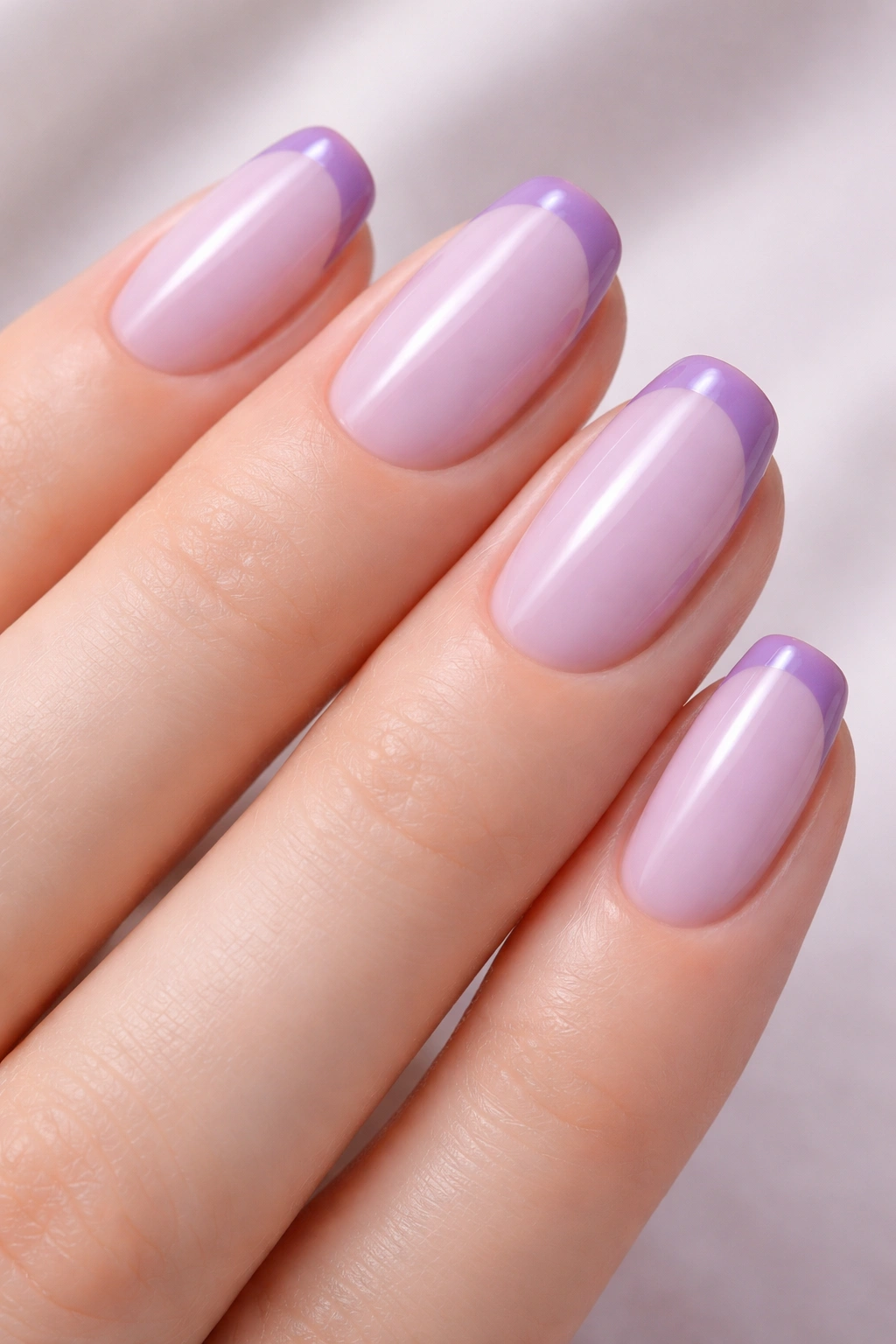 Close-up of lavender to lilac gradient nails with micro French tips
