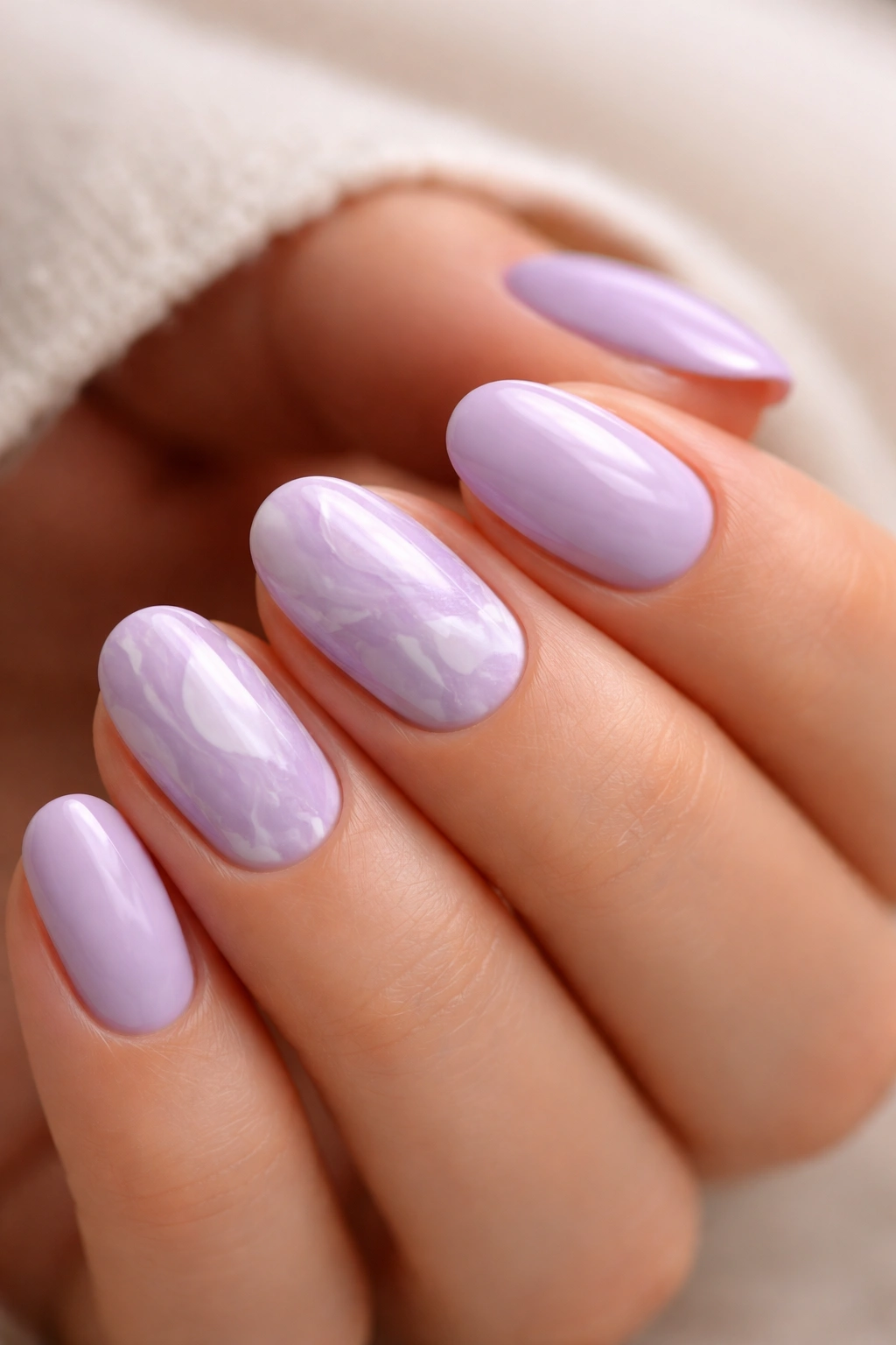 Lavender marble nails on short oval nails with soft veining