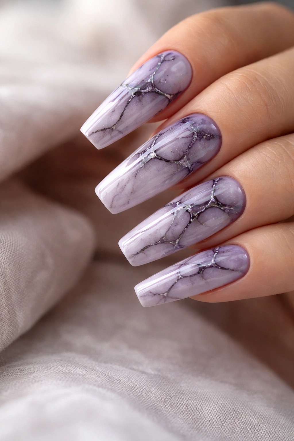 Close-up of lavender marble coffin nails with dark veining
