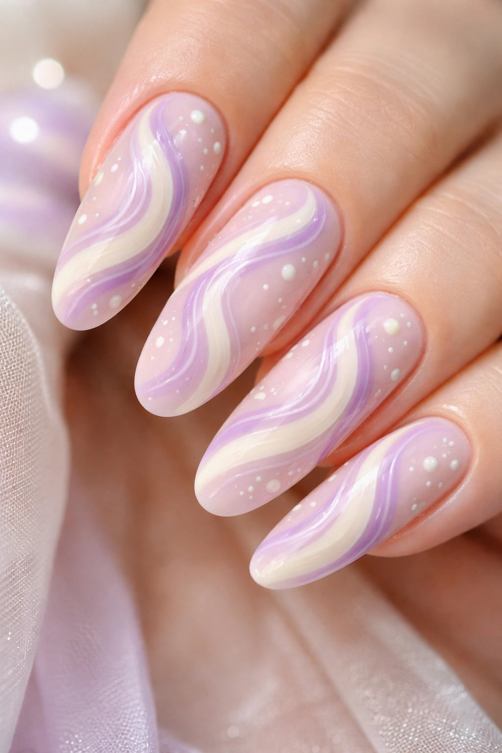 Nails with lavender cream swirls and tiny dots close-up.
