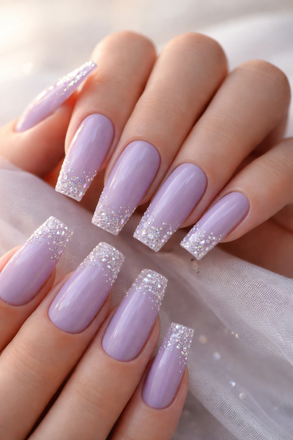 Close-up of lavender coffin nails with small crystals on tips and edges