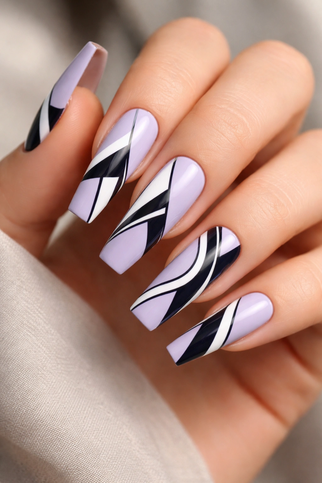 Lavender coffin nails with hand-painted geometric shapes in black white navy