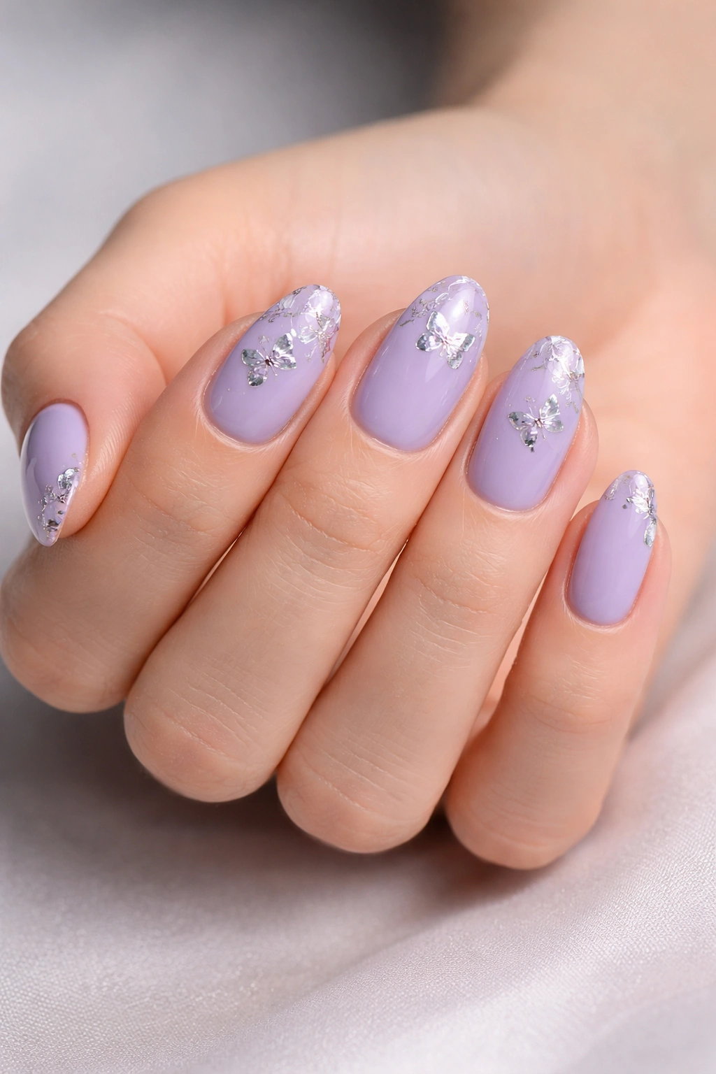 Lavender short almond nails with silver butterfly foil accents