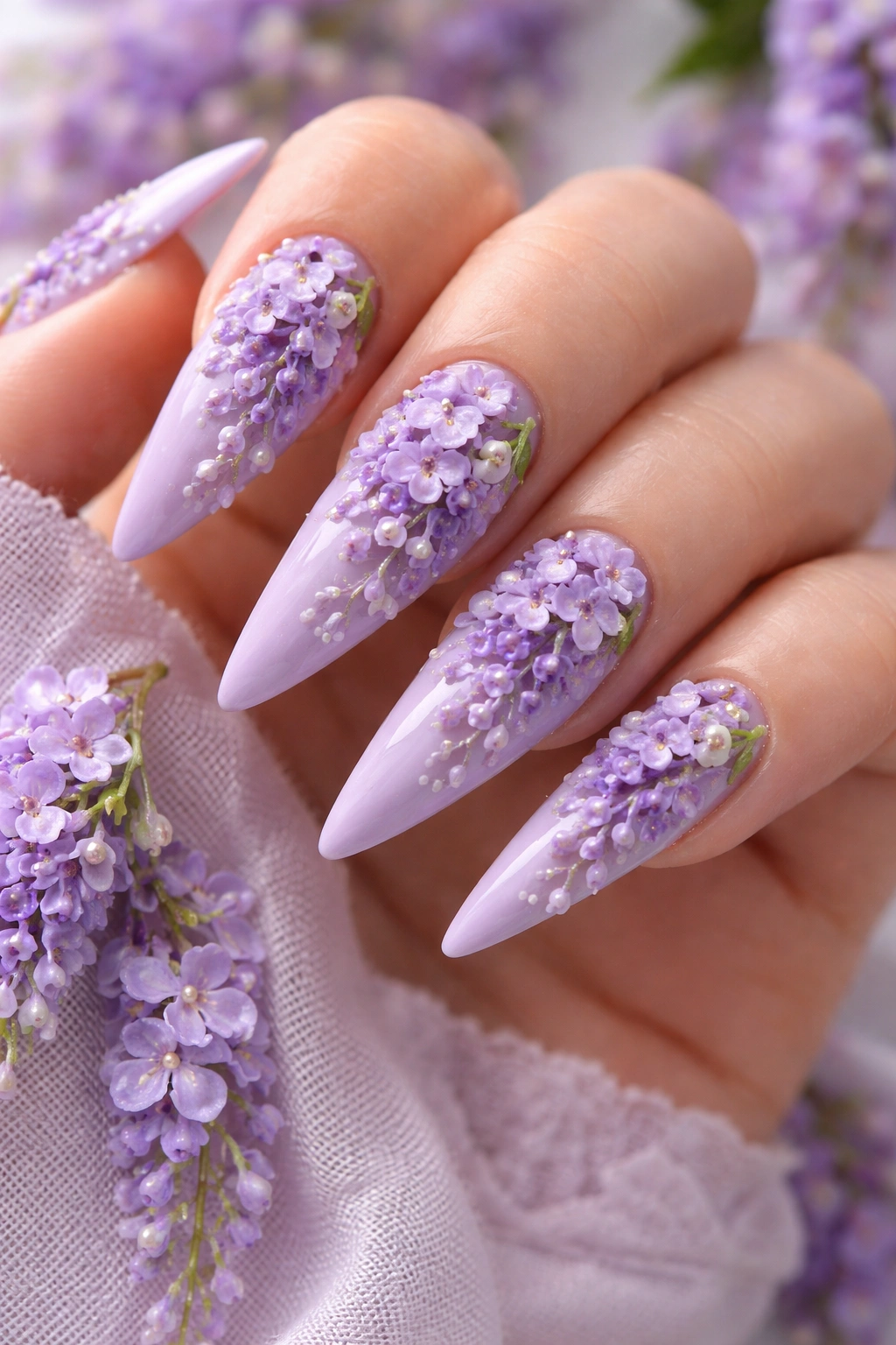 Close-up lavender stiletto nails with cascading 3D wisteria