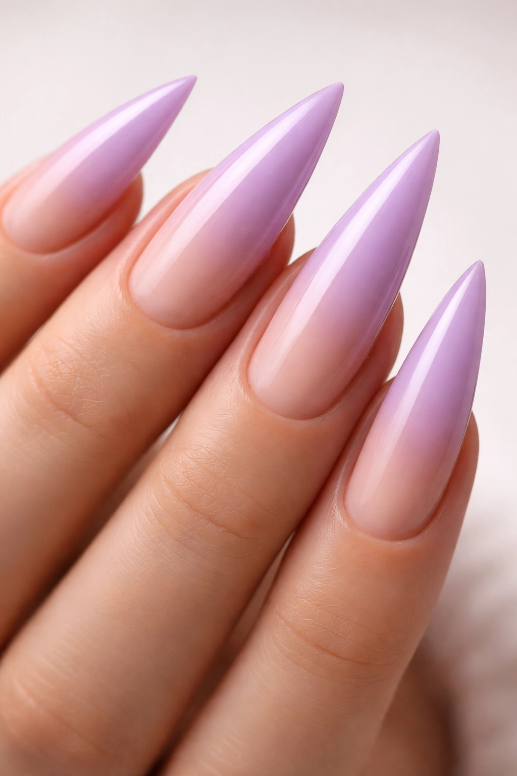 Lavender to nude ombre on long stiletto nails