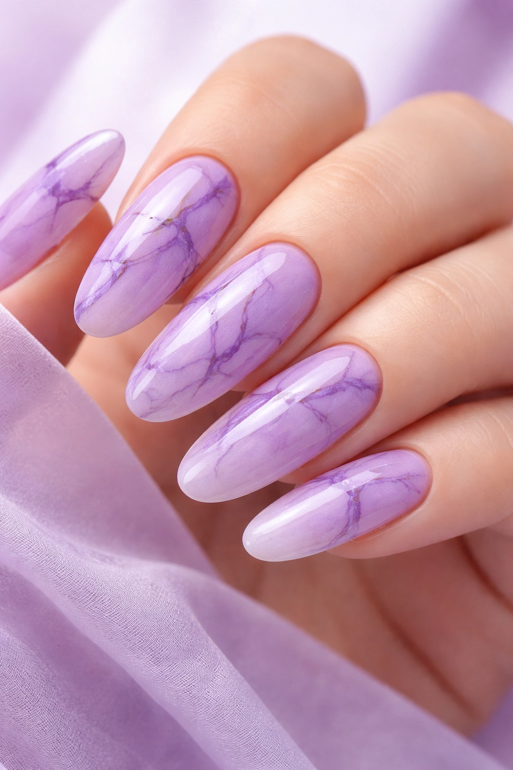 Close-up of lavender and purple marble nails