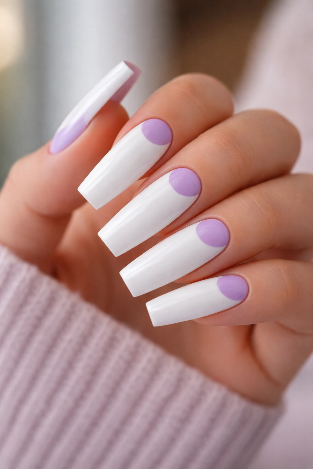 Close-up of reverse French lavender and white coffin nails
