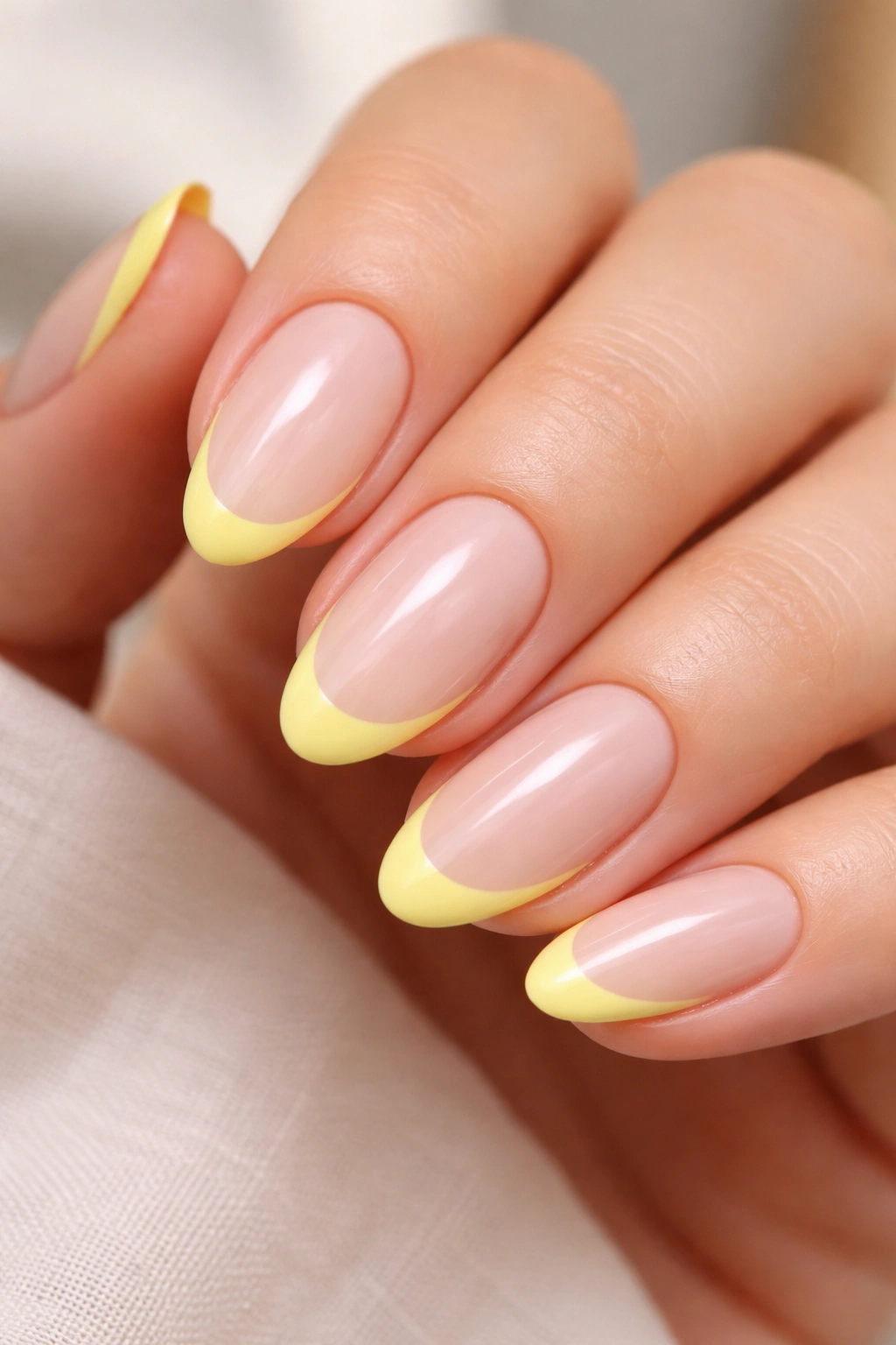 Nude base with lemon French tips on short almond nails