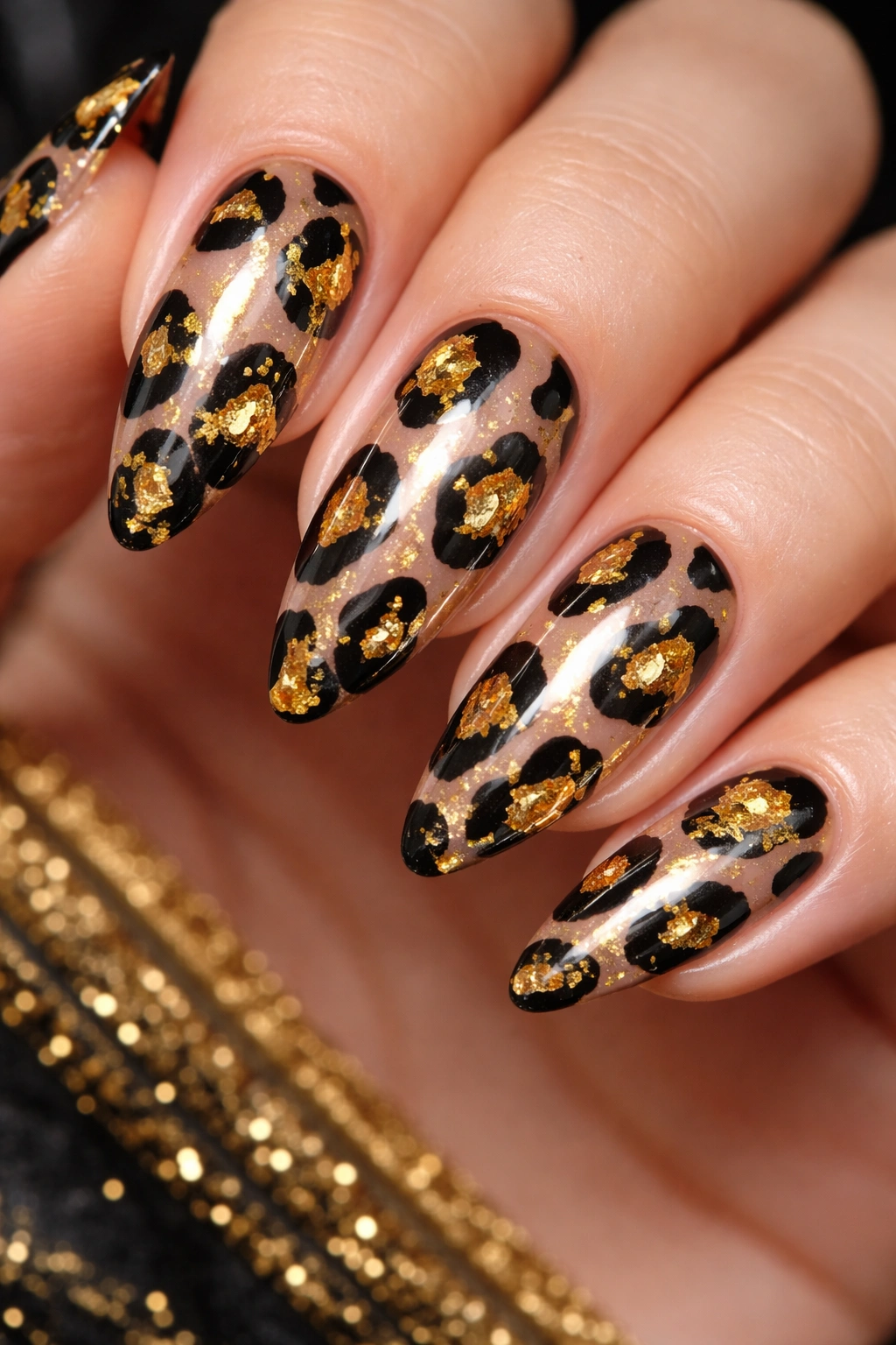 Nude nails with black leopard spots outlined in gold foil