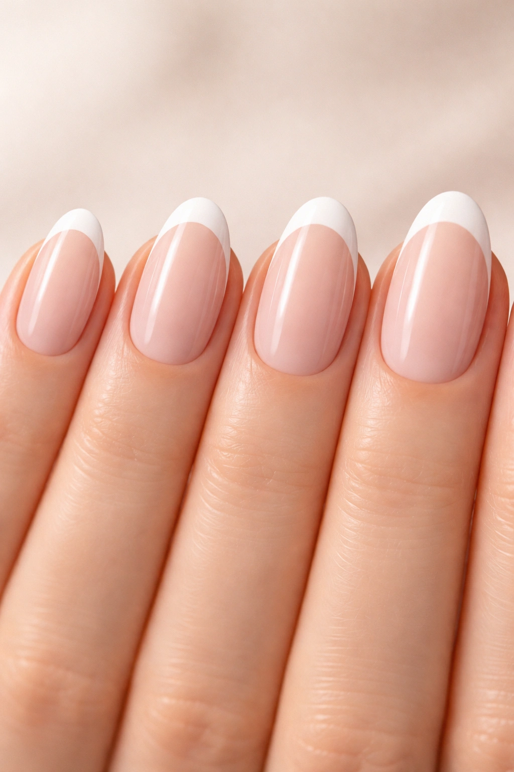 Nails with thin, medium, and thick French tips on a plain background