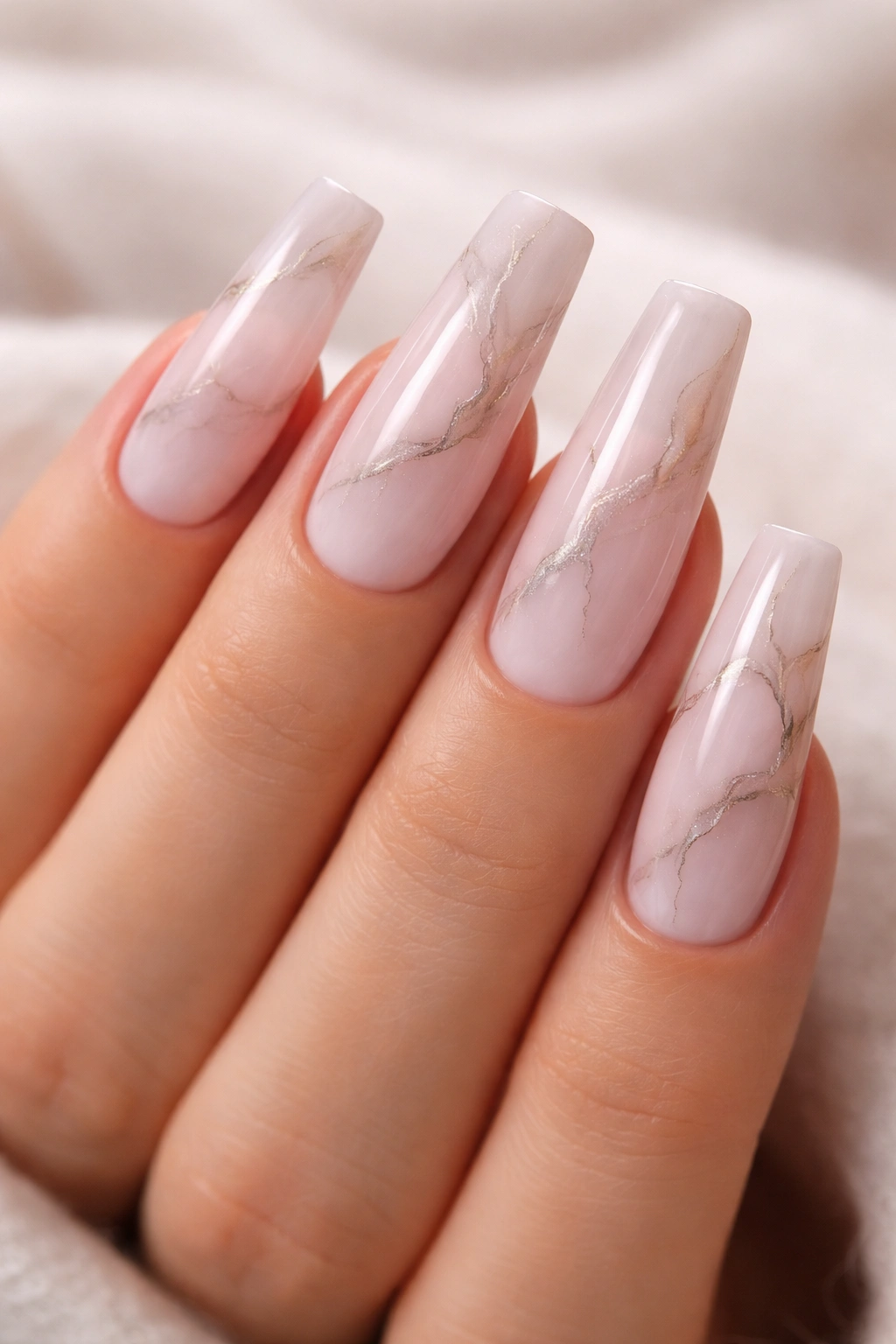 Light pink coffin nails with subtle marble veining