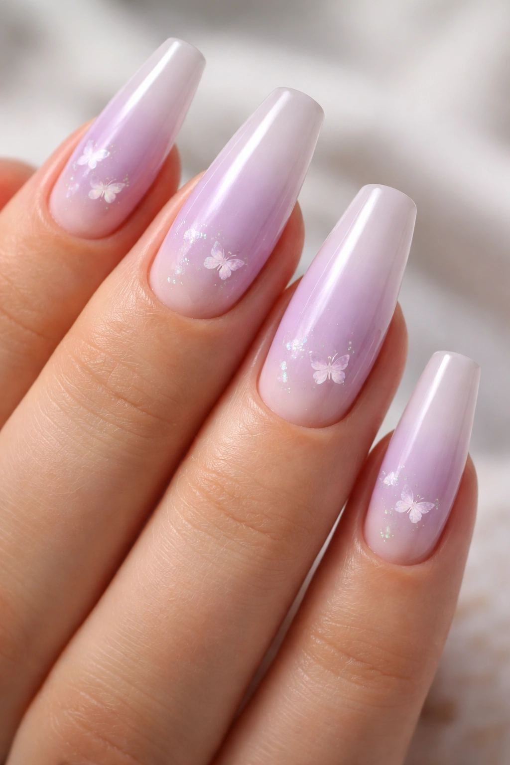 Lilac aura nails with tiny micro butterflies on a soft base