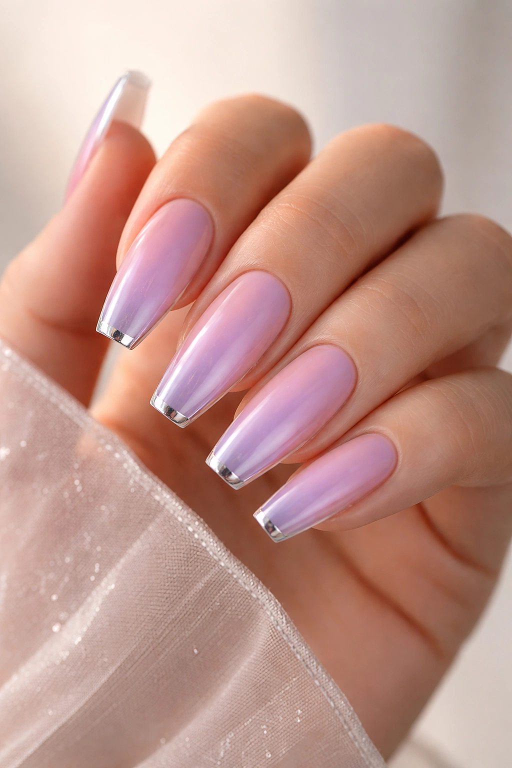Lilac aura nails with a thin silver edge on ballerina tips
