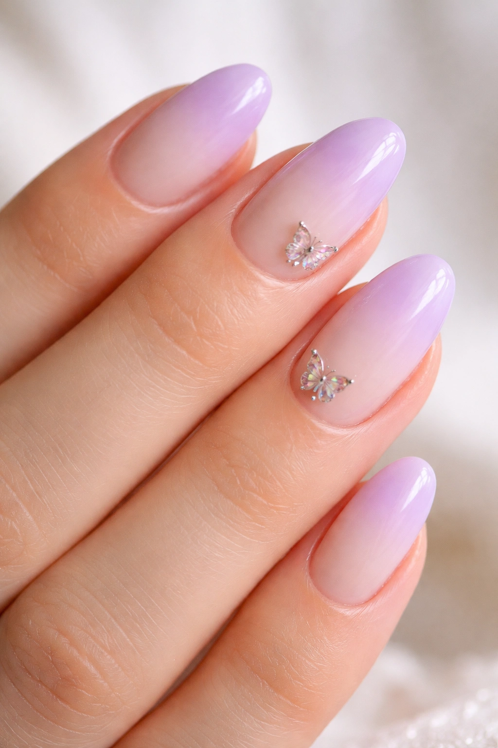 Lilac French fade nails with tiny butterfly charms