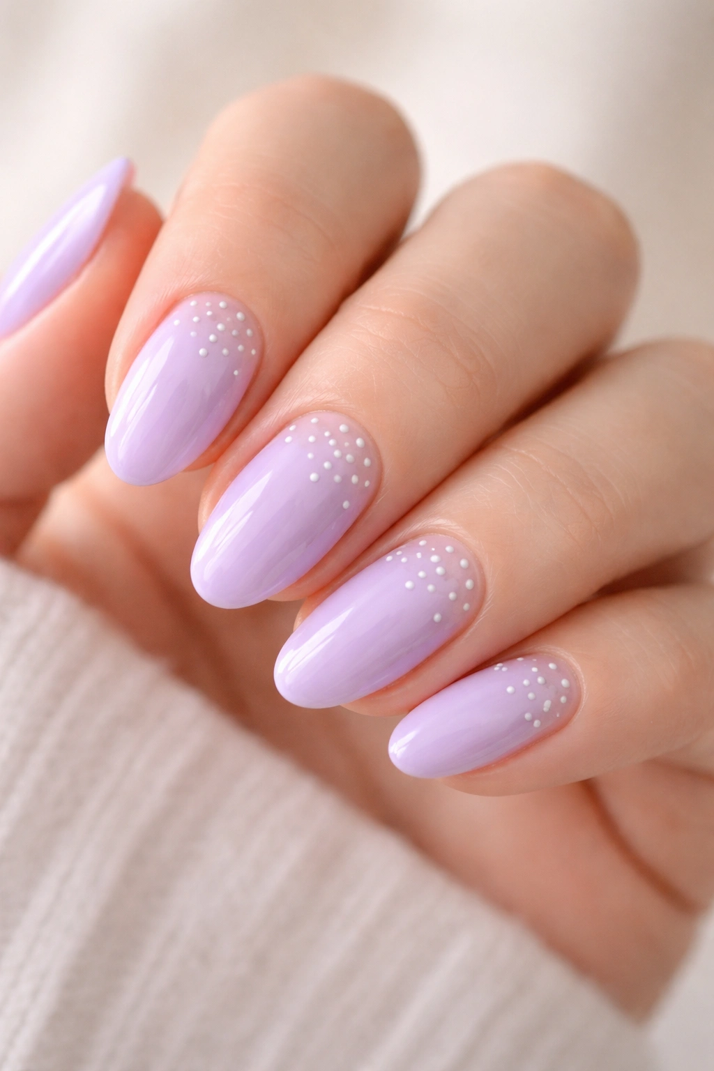 Short almond nails with lilac base and tiny white dots