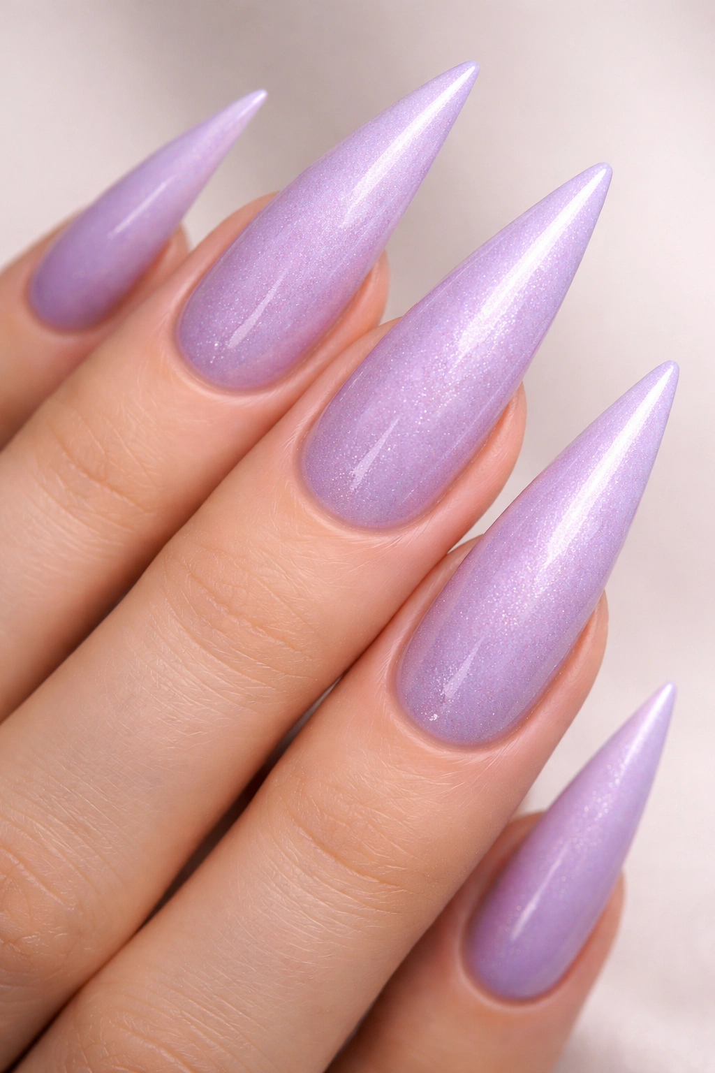 Soft lilac stiletto nails with integrated shimmer