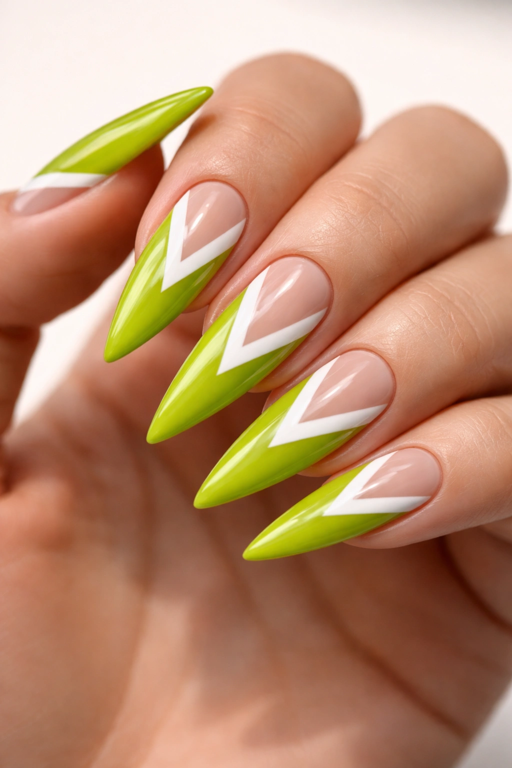 Lime green nails with white triangles negative space on stiletto shape