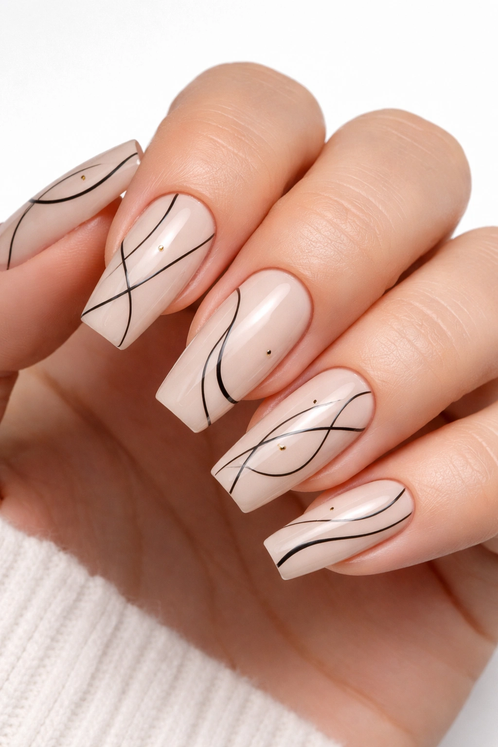 Coffin nails with simple black line art on nude base