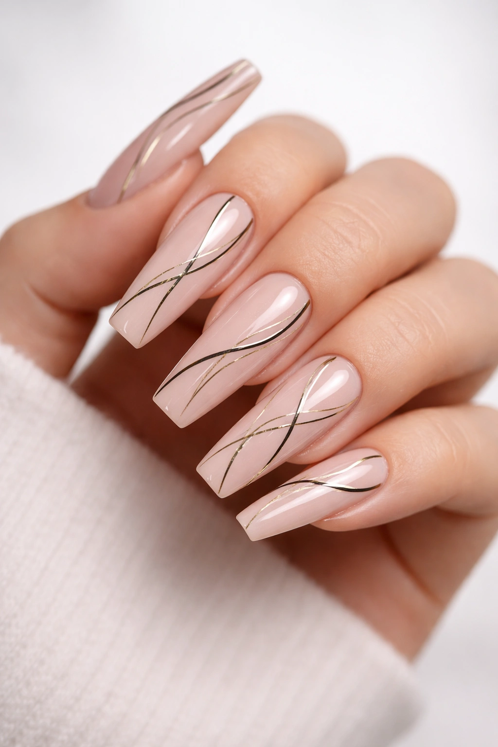 Nude coffin nails with fine black line art patterns