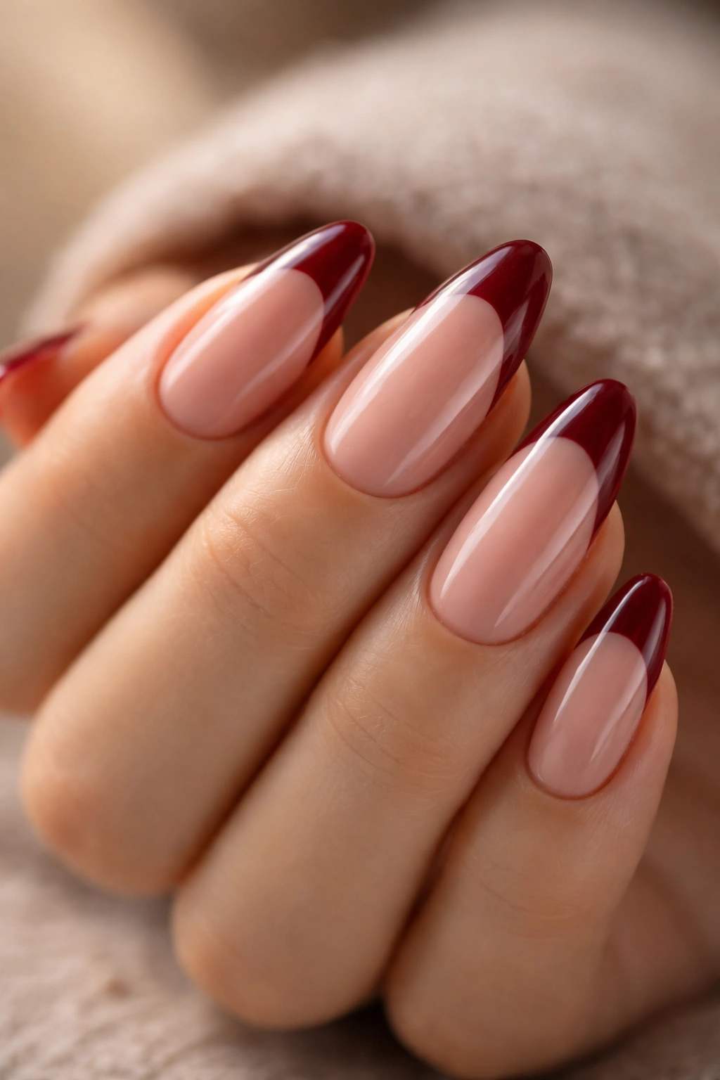 Almond nails with glossy red tips and top coat shine