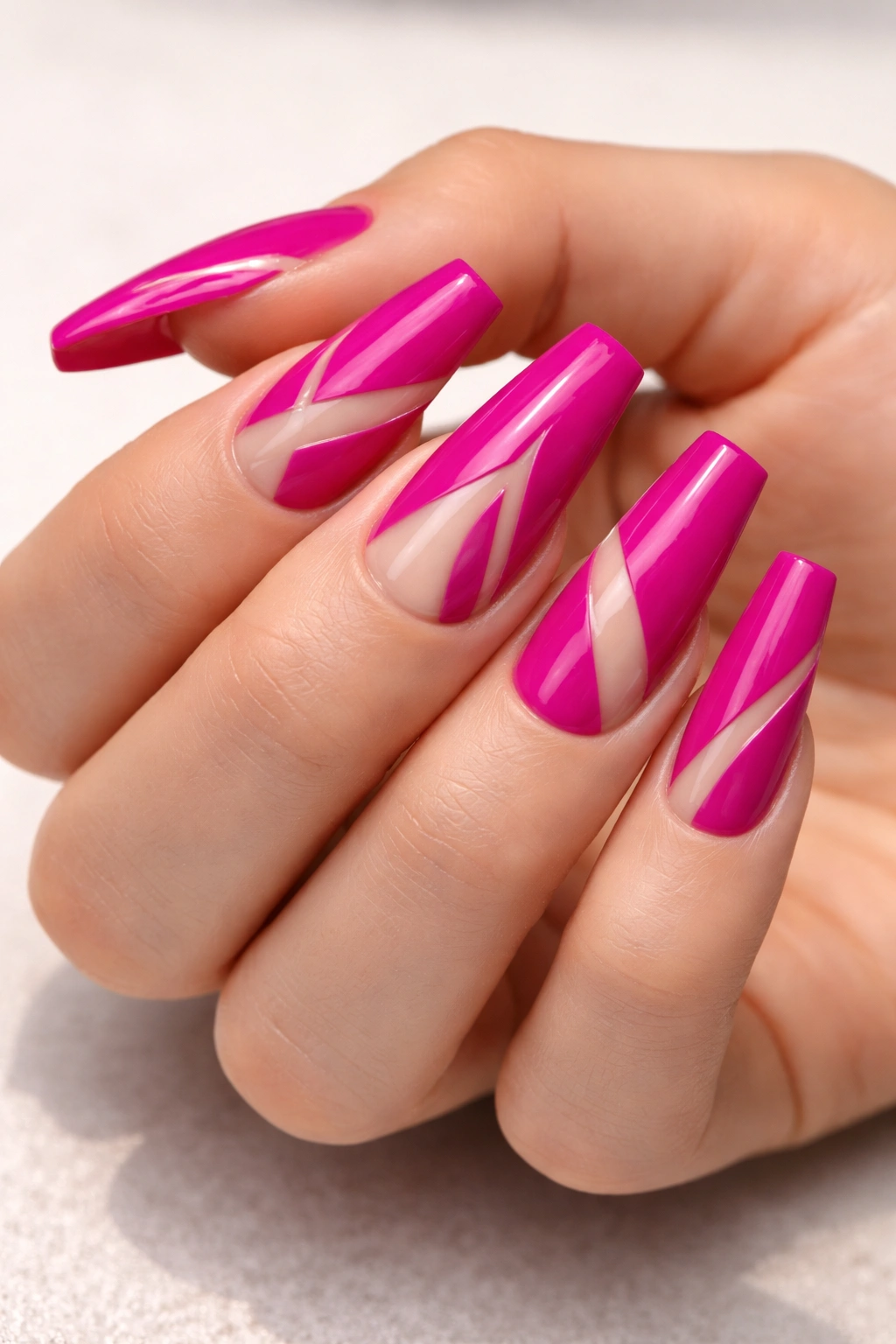 Close-up of coffin nails in bright magenta with negative-space geometric patterns.