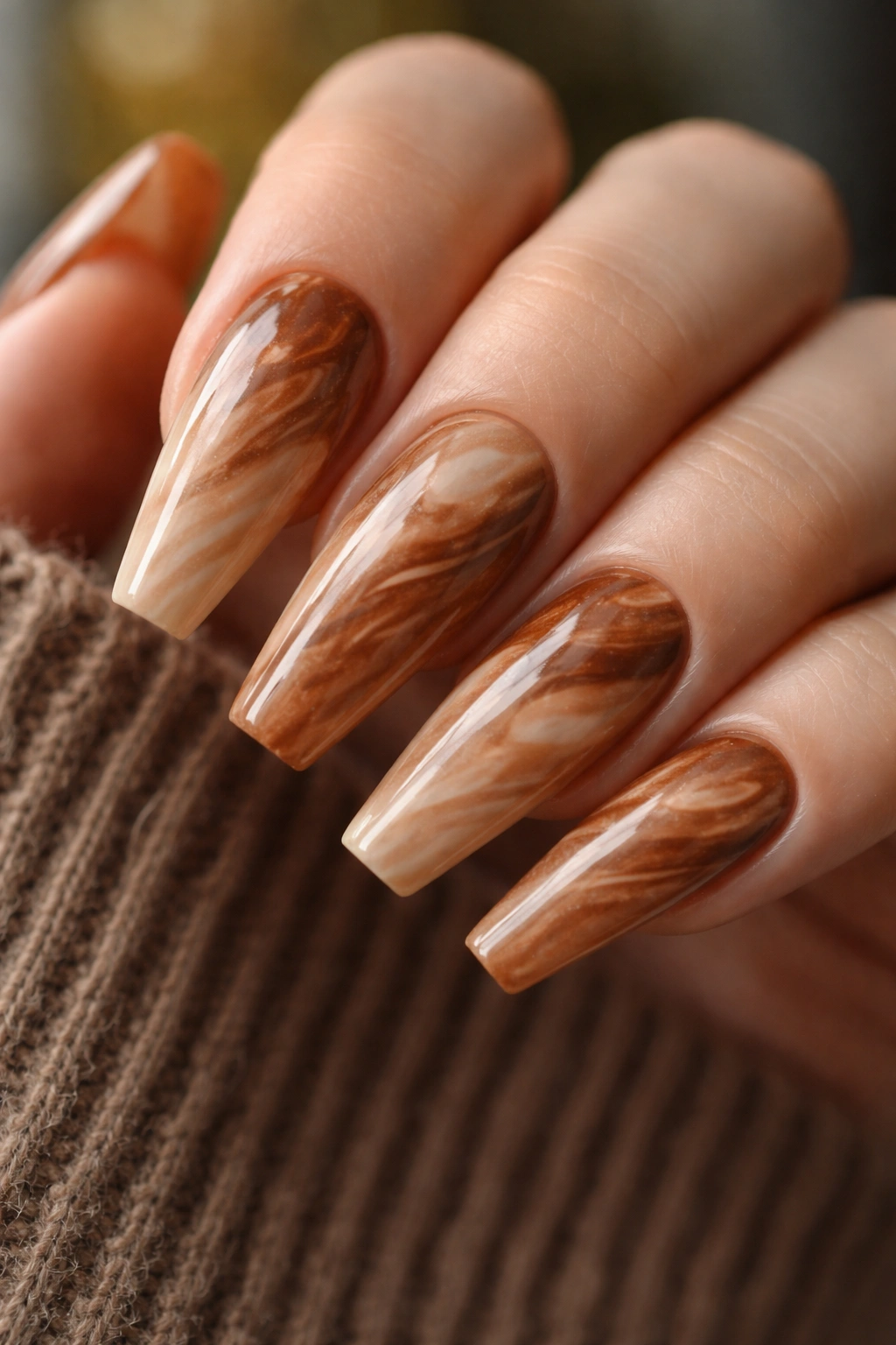 Maple toffee marble nails on a ballerina shape with soft swirls