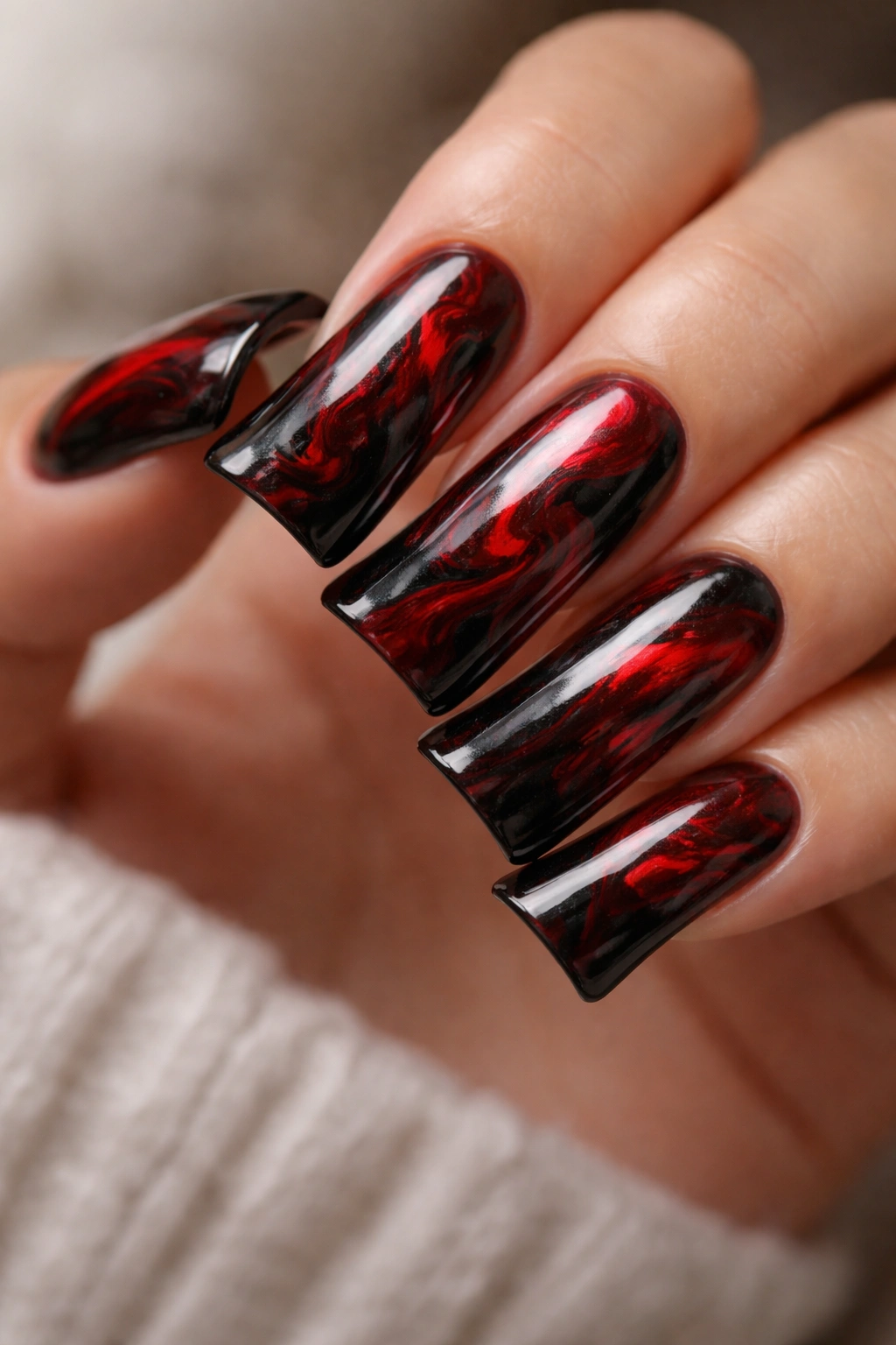 Black and red marble pattern on duck nails