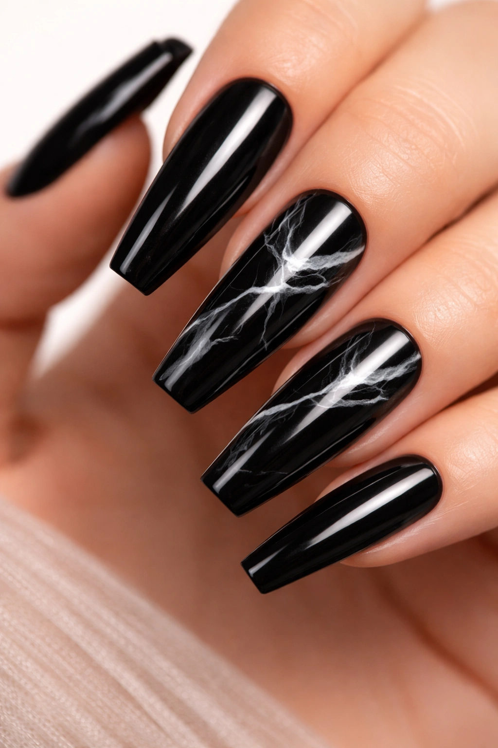 Glossy black nails with sparse white marble veins
