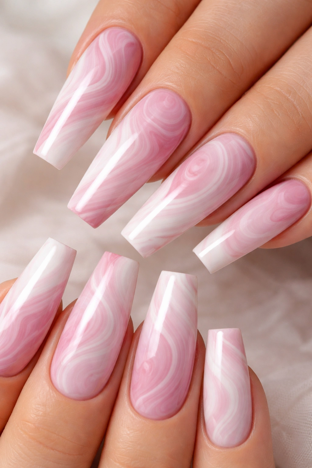 Close-up of long coffin nails with pink and white marble swirl