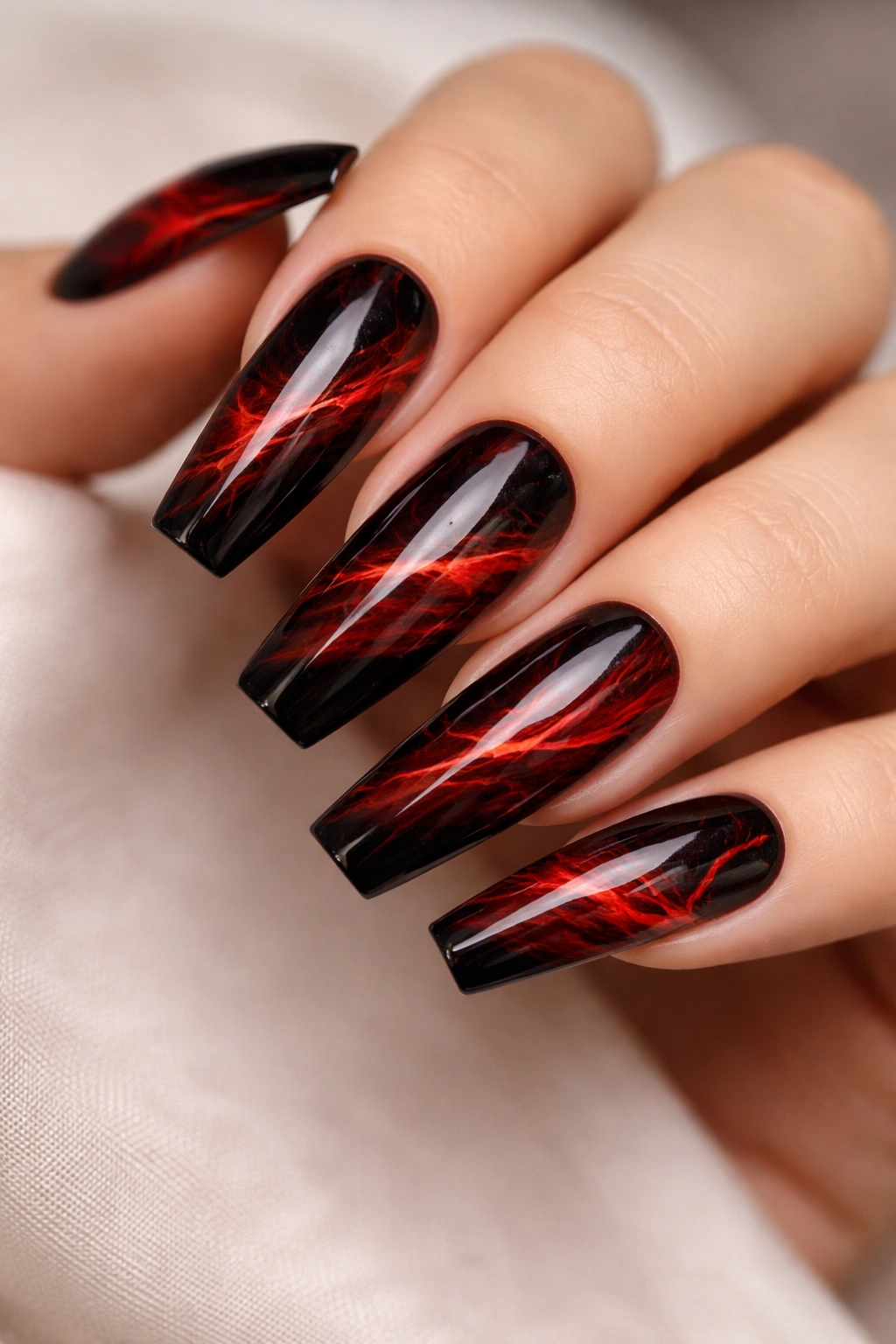 Close-up of coffin nails with red marble veining on black base