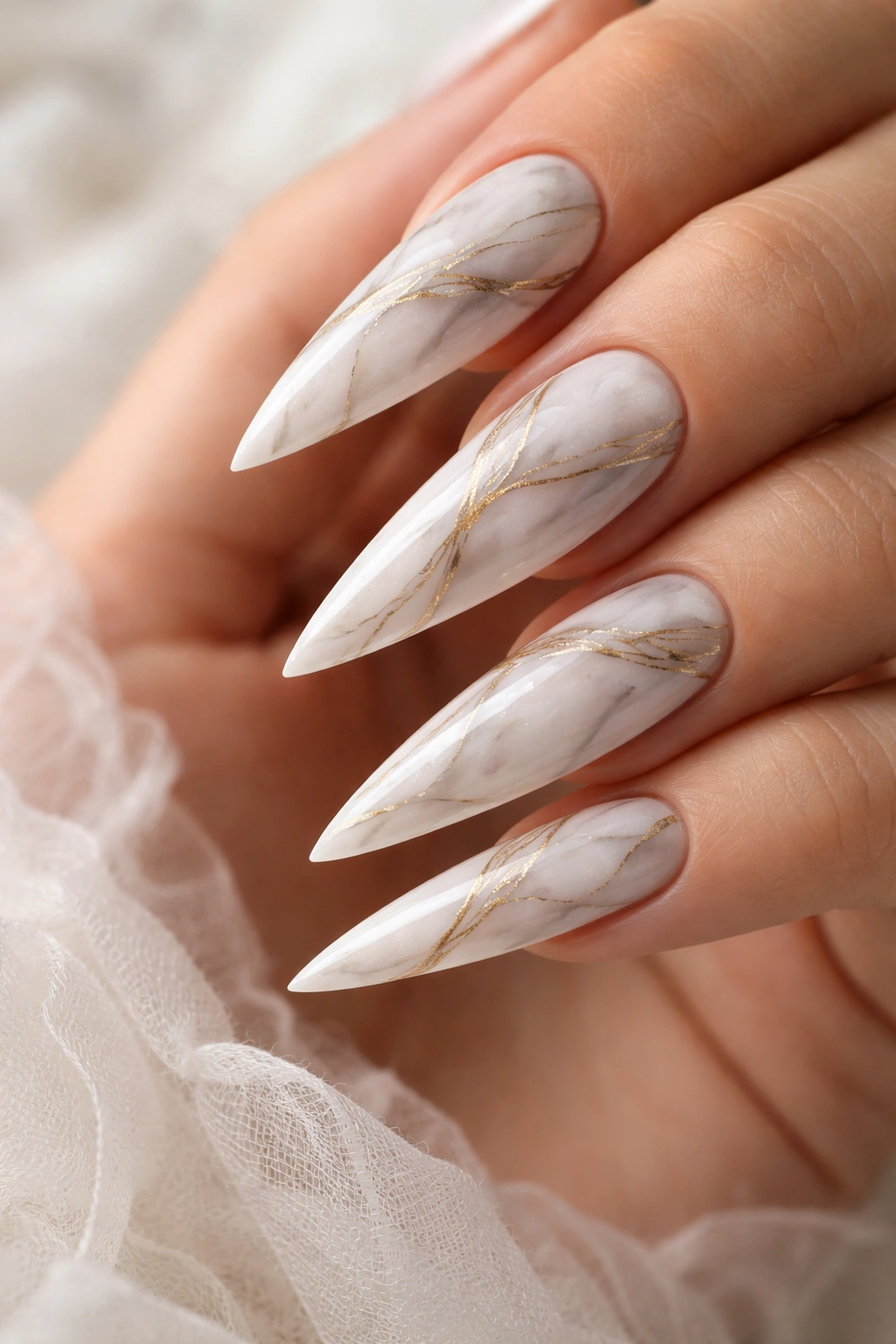 White stiletto nails with marble swirl pattern