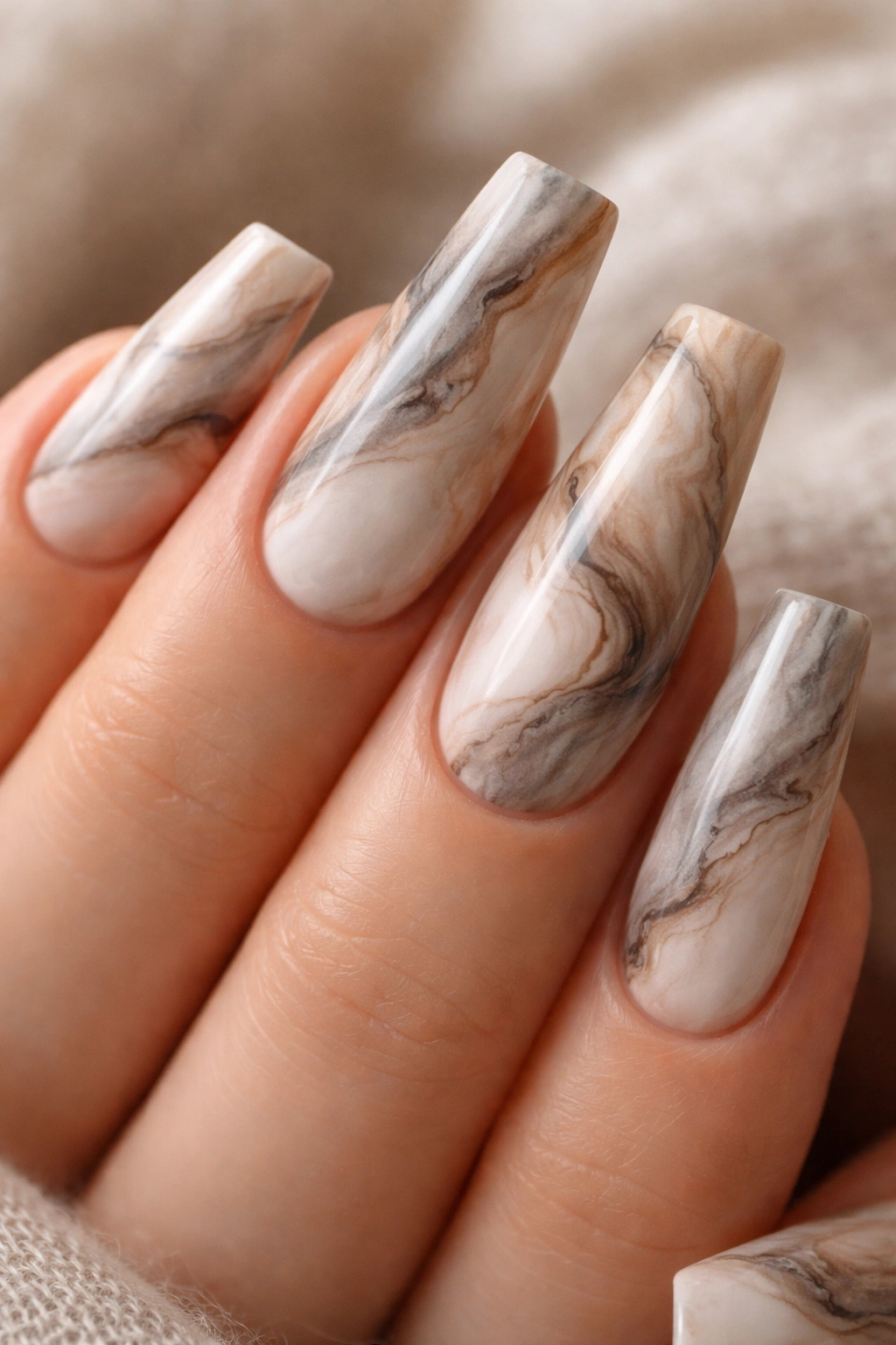 Close-up of slim duck nail with neutral marble swirl design