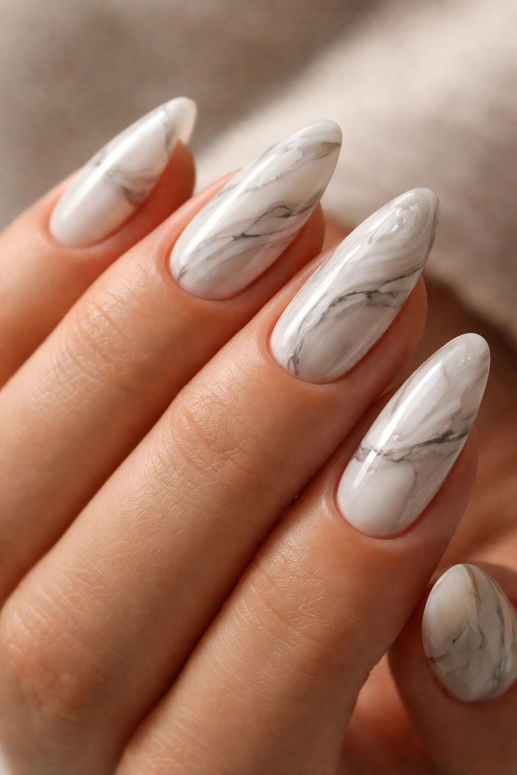Close-up of marble swirls nails with gray veining