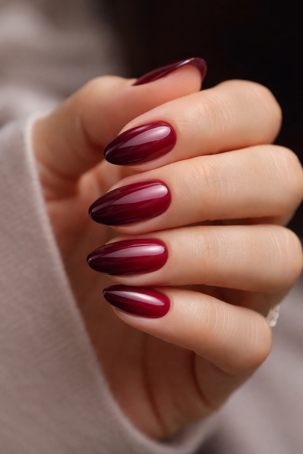 Short almond nails with maroon to plum gradient, glossy finish