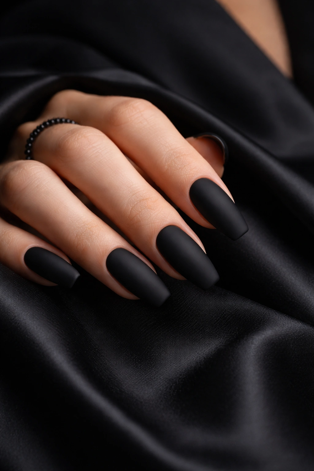 Close-up of hand with Sophisticated Black Nails matte finish