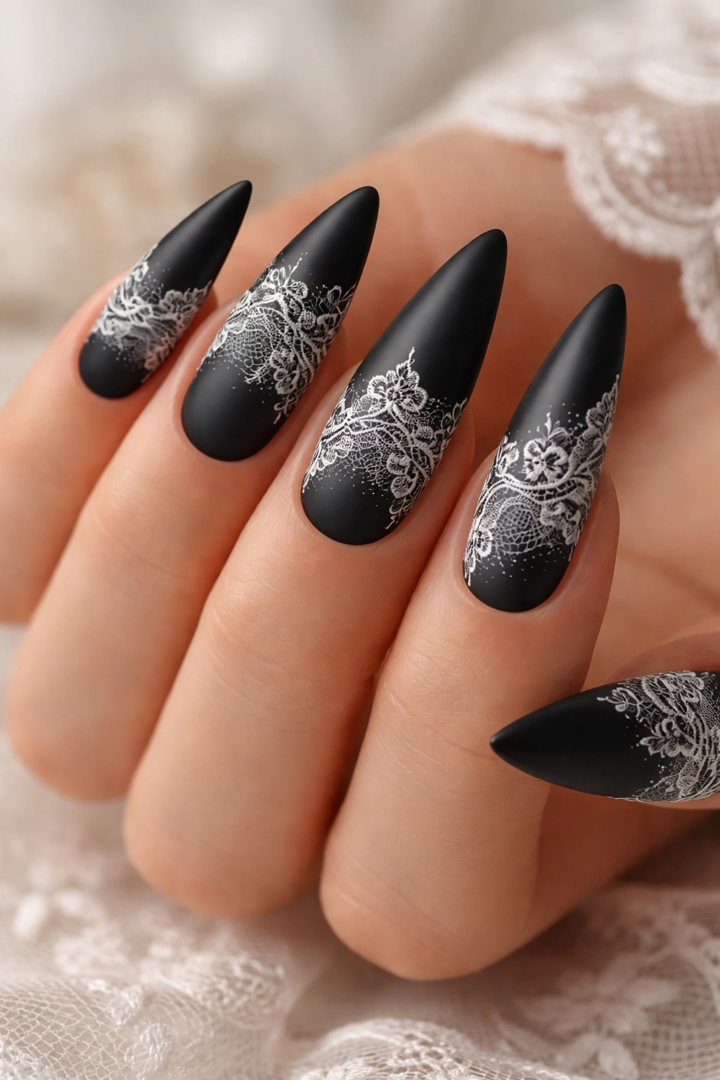 Matte black nails with delicate white lace detailing