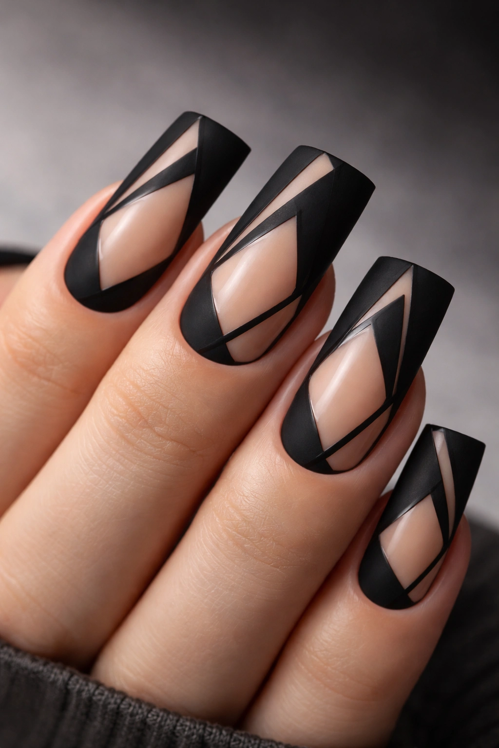 Nude-based duck nails with matte black geometric design and negative space.