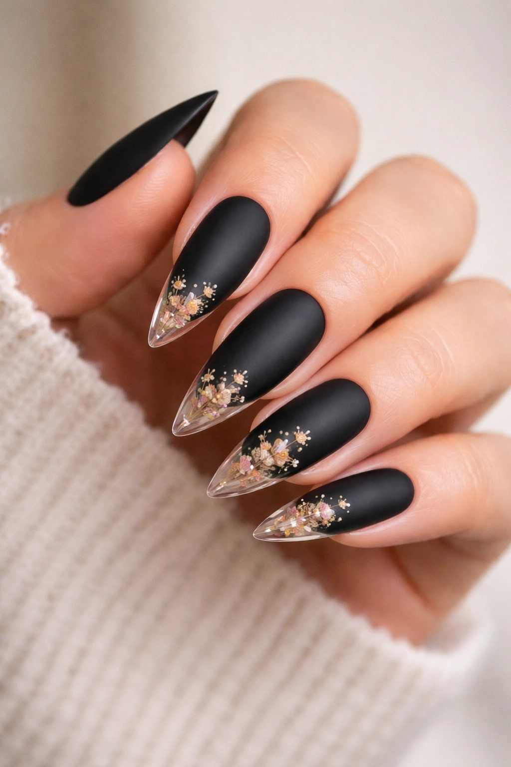 Matte black nails with pressed flowers under clear topcoat