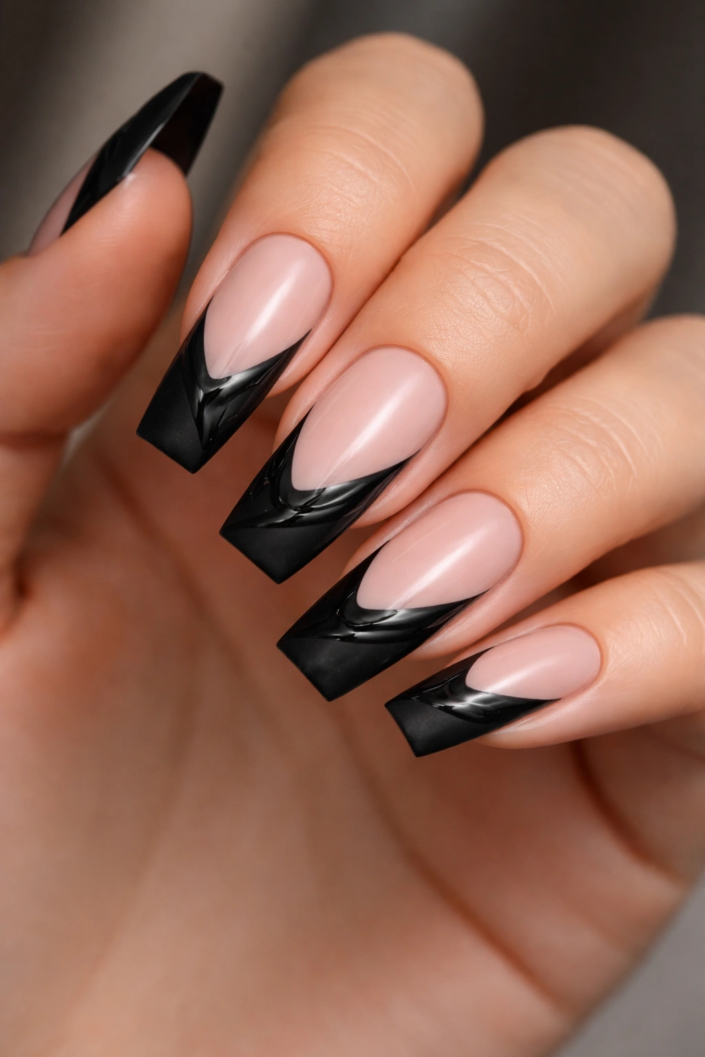 Close-up nails with matte black tips and gloss art
