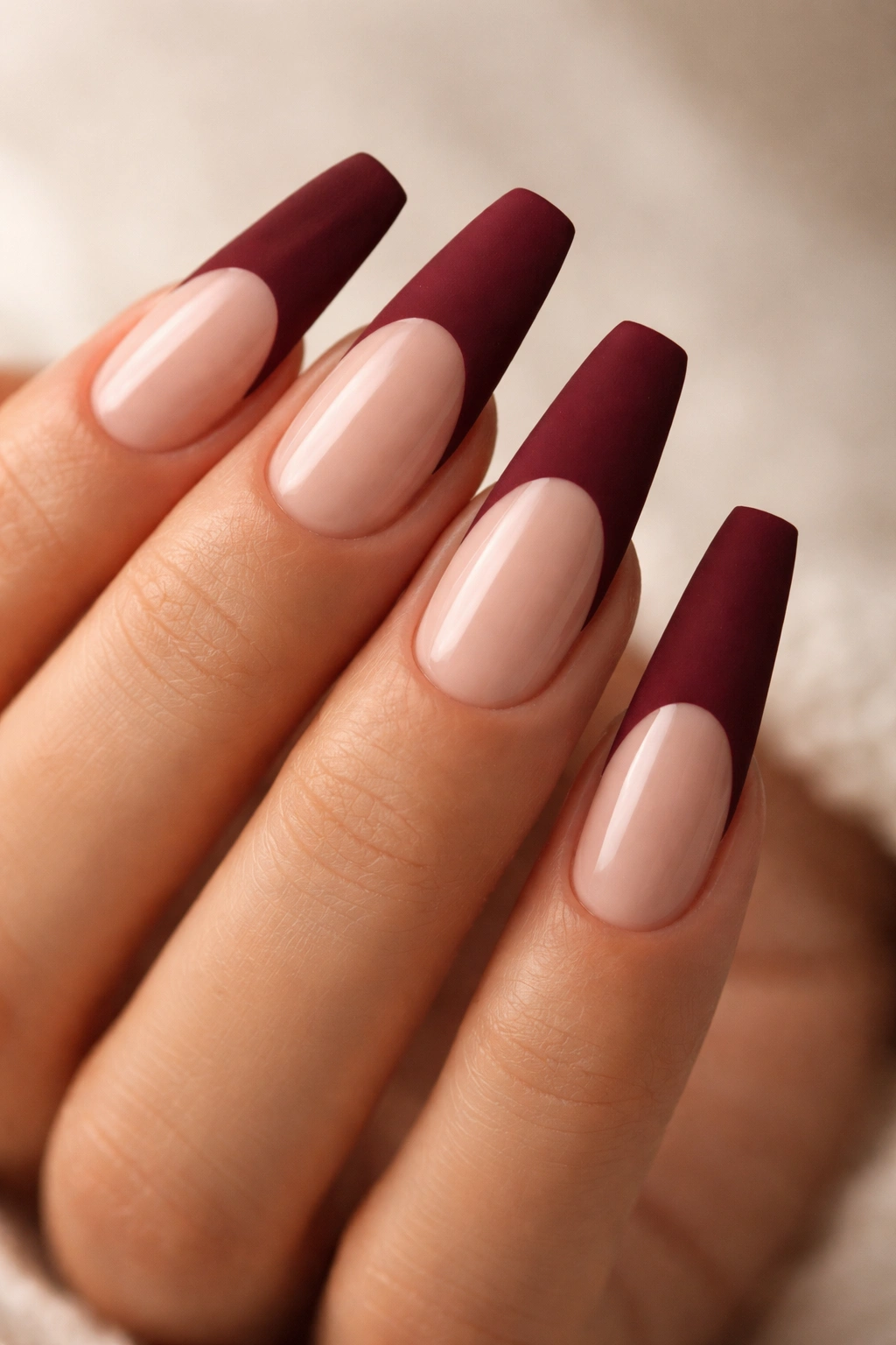 Matte burgundy tips on coffin nails with glossy nude base
