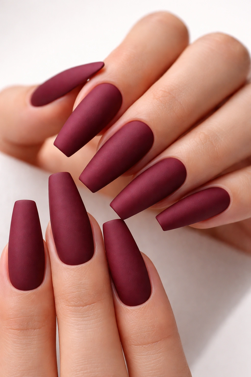Matte burgundy coffin nails with velvety finish